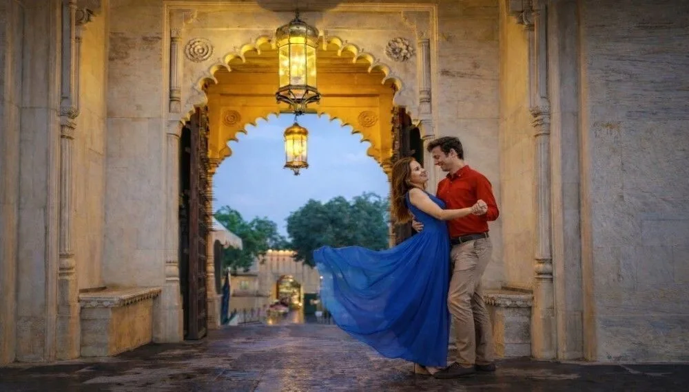 Best honeymoon places in India in December couple in Udaipur palace archway