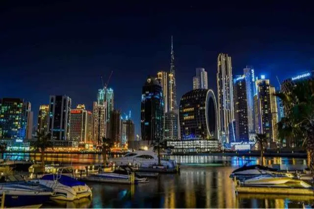 Dubai Marina night view with illuminated skyscrapers and water reflections