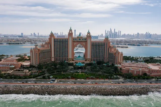 Dubai tour package view with Atlantis-style luxury hotel, coastline and skyline from the sea