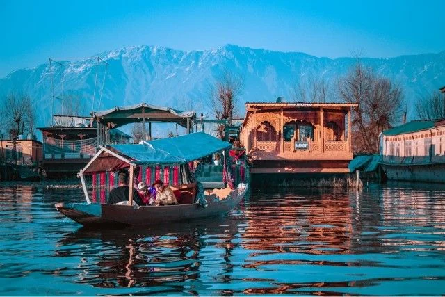 Shikara ride at Dal Lake Srinagar with houseboats, part of Jammu Kashmir tour package