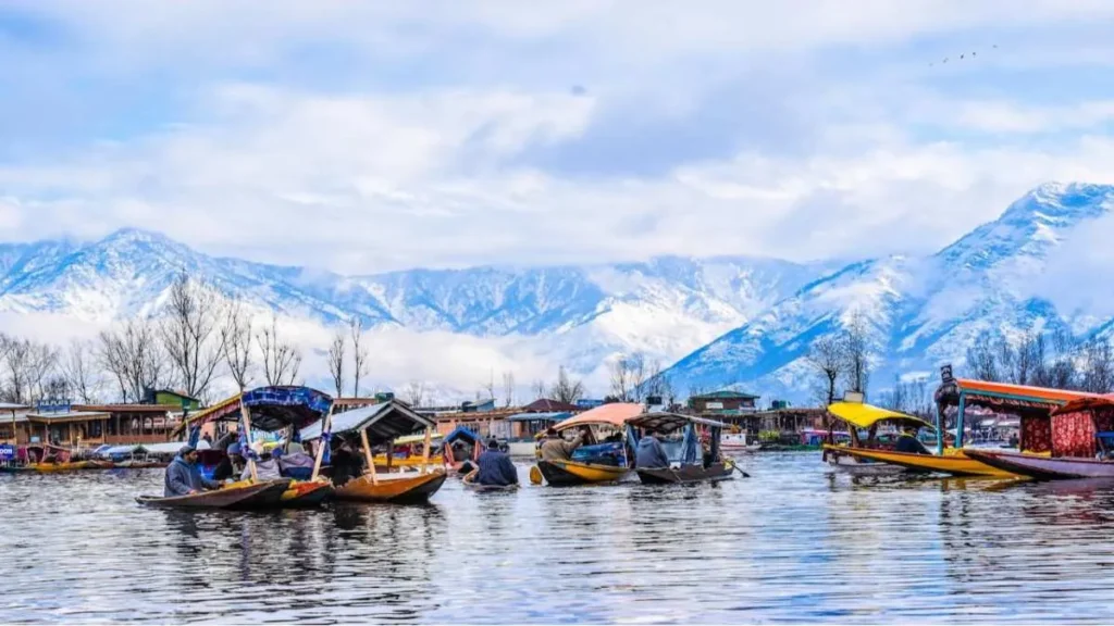 Dal Lake Srinagar me shikara boats and snow mountains ka scenic view”
