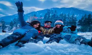 Group of friends enjoying snow in Shimla and Manali during a winter tour from Delhi.