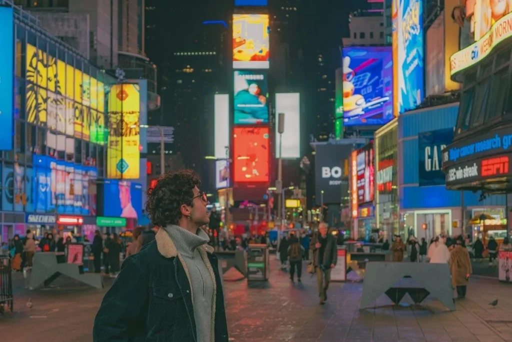 Traveler in Times Square New York featured in Best Places to Visit in USA for First Time guide