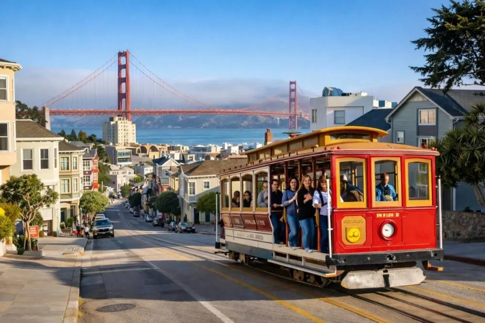 San Francisco cable car with Golden Gate Bridge in the background on a sunny day
