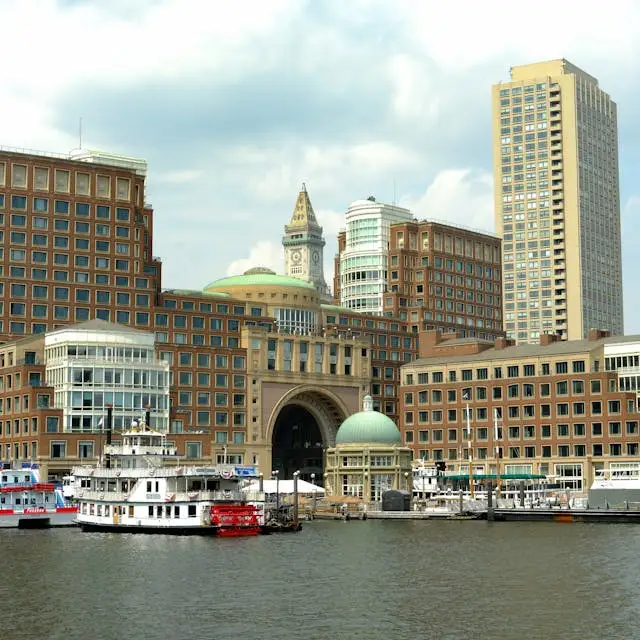 Boston waterfront skyline with hotels, harbor boats,