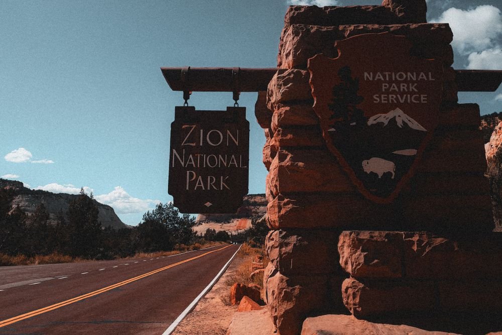 The official entrance sign of Zion National Park in Utah, featured among the best national parks to visit in September.