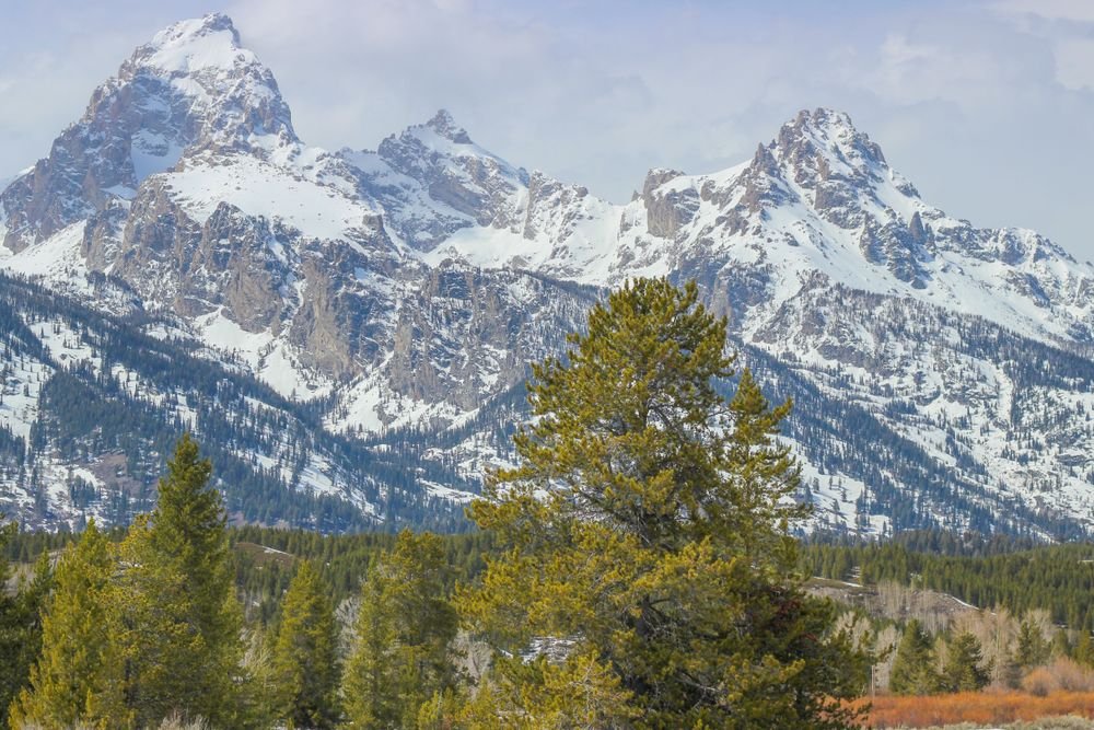 Snow-capped mountain peaks at Grand Teton National Park, one of the best national parks to visit in August.