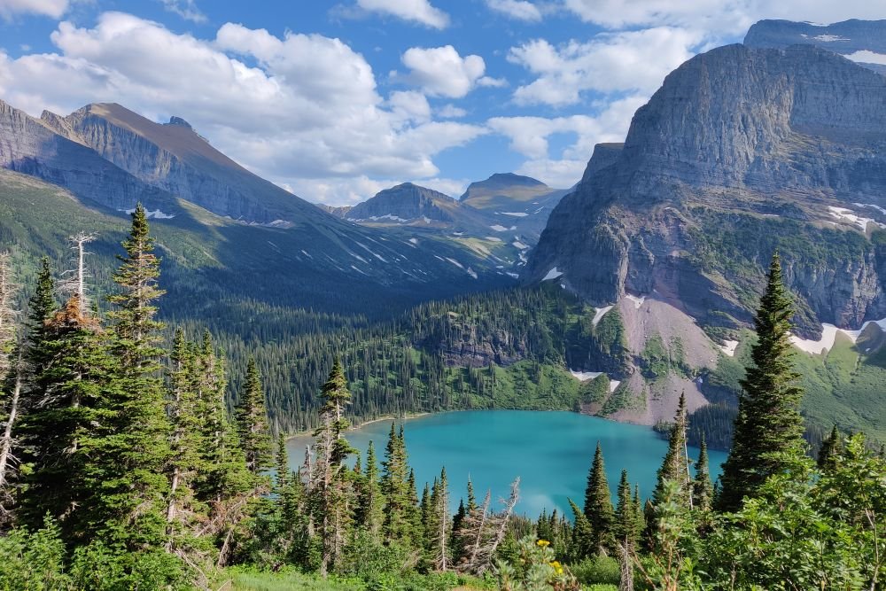 A stunning turquoise alpine lake surrounded by rugged mountains at Glacier, one of the best national parks to visit in September.