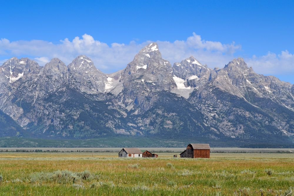 Snow-capped Grand Teton mountains in Wyoming, making it one of the best national parks to visit in June.