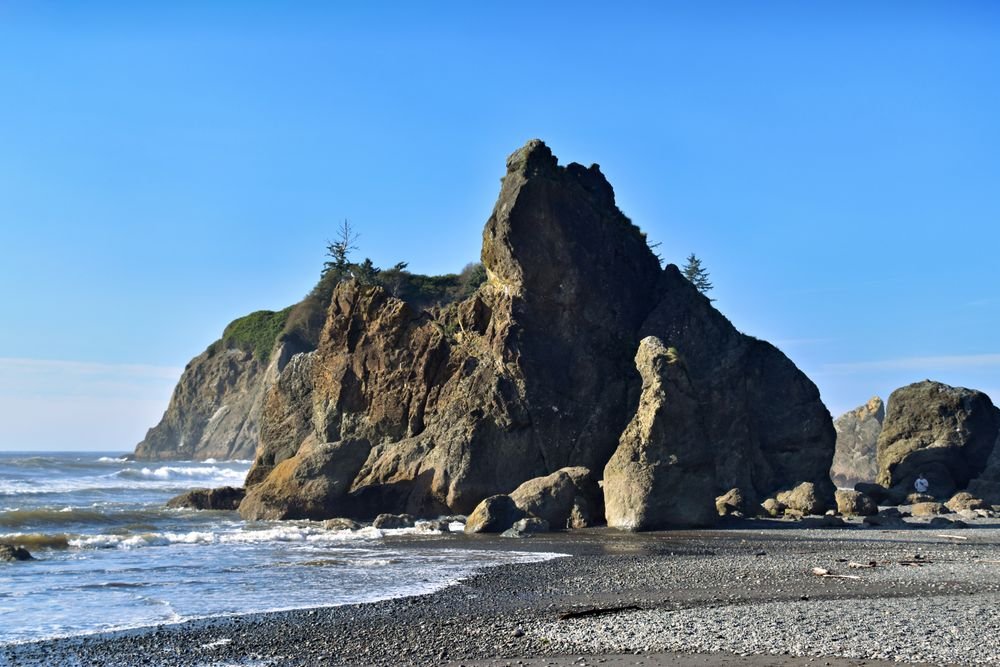 Massive rocky sea stacks on the misty Pacific coastline at Olympic, one of the best national parks to visit in September.
