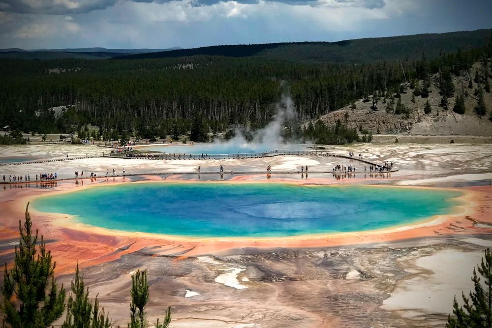 Colorful Grand Prismatic Spring geothermal pool at Yellowstone National Park, one of the best national parks to visit in August.