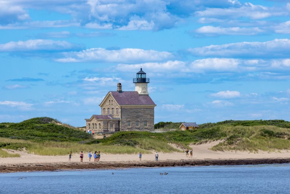 Historical stone lighthouse on Block Island, one of the best islands to visit in july for summer vacations.